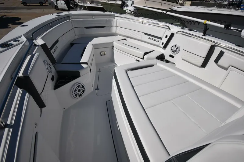 Slide: The Image of 2021 Blackfin 332 CC boat interior with white seating and speakers. - 18