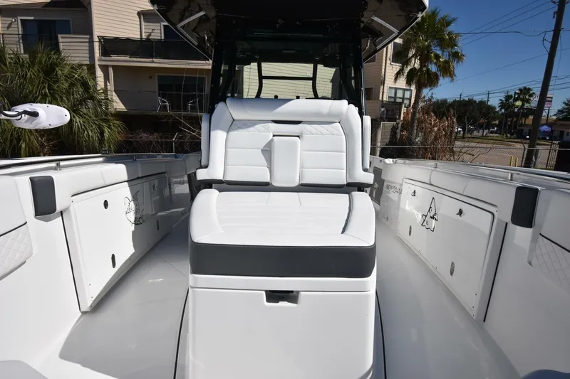 Slide: The Image of 2021 Blackfin 332 CC boat interior with white seating and storage compartments. - 19