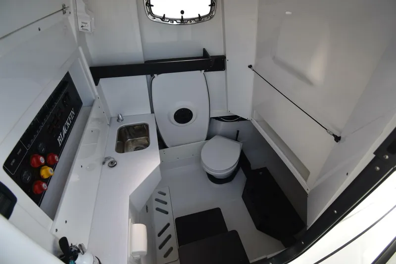 Slide: The Image of 2021 Blackfin 332 CC boat interior with sink, toilet, and control panel. - 25