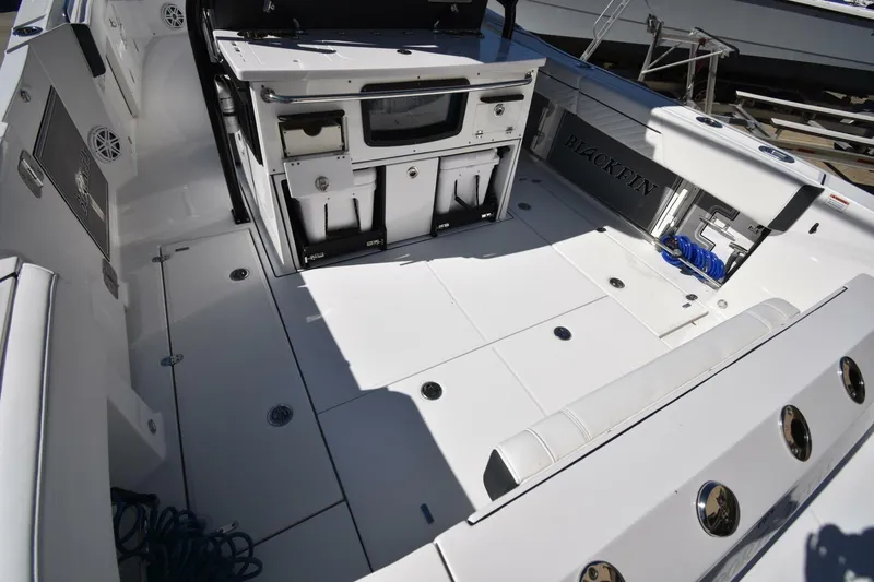 Slide: The Image of 2021 Blackfin 332 CC boat deck with storage and seating. - 8