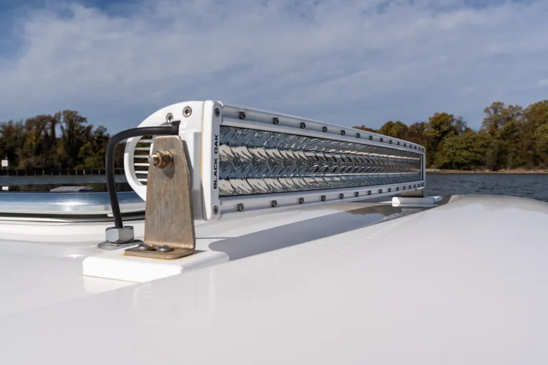 Slide: The Image of 2023 Back Cove 340 boat with mounted light bar, scenic water and trees in background. - 77
