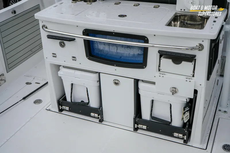 Slide: The Image of 2026 Blackfin 332 CC boat interior with storage compartments and sink. - 15