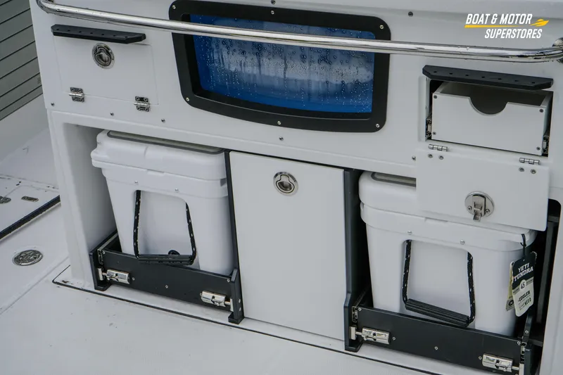 Slide: The Image of 2026 Blackfin 332 CC boat storage area with coolers and compartments. - 16
