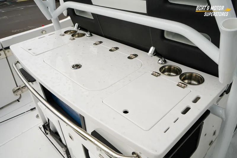 Slide: The Image of 2026 Blackfin 332 CC boat's sleek white deck with integrated cup holders and storage. - 20