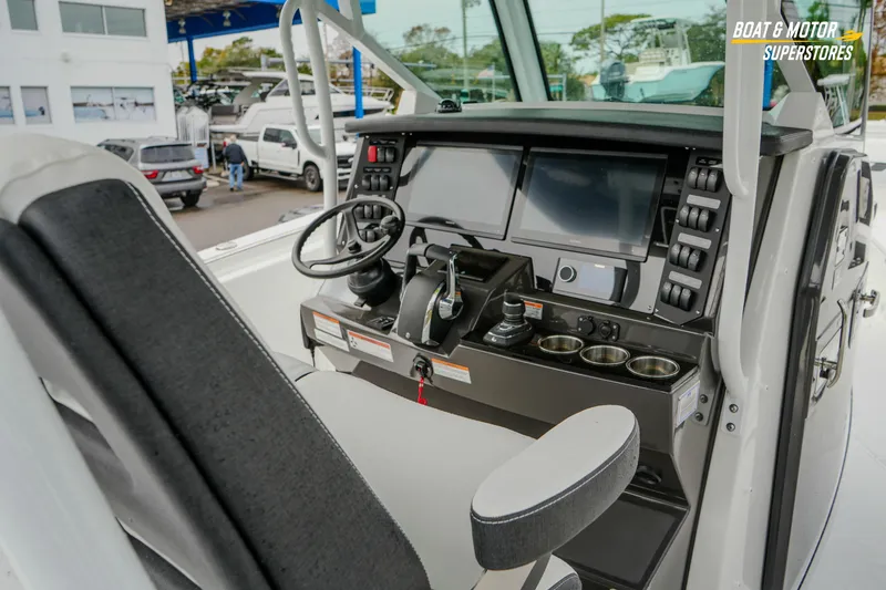 Slide: The Image of 2026 Blackfin 332 CC boat cockpit with modern controls and displays. - 21