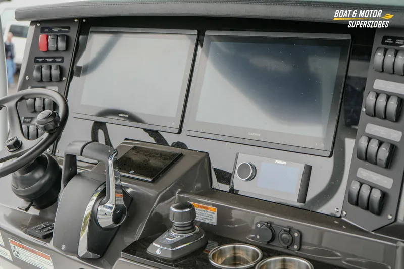 Slide: The Image of 2026 Blackfin 332 CC boat dashboard with dual Garmin displays and control panel. - 23