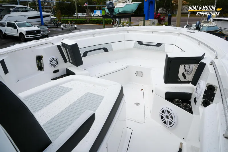 Slide: The Image of 2026 Blackfin 332 CC boat interior with seating and speakers at a dealership. - 26
