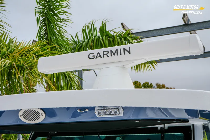 Slide: The Image of 2026 Blackfin 332 CC boat with Garmin radar, surrounded by palm trees. - 33