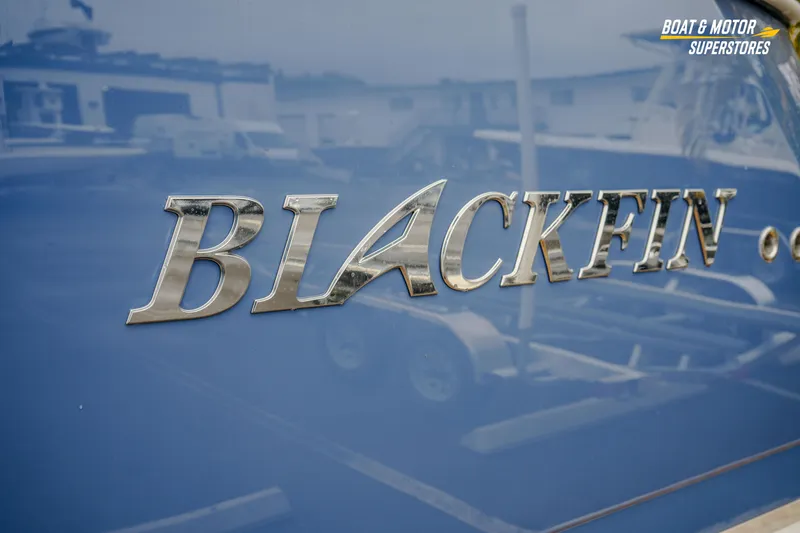 Slide: The Image of 2026 Blackfin 332 CC boat logo on a blue surface. - 7