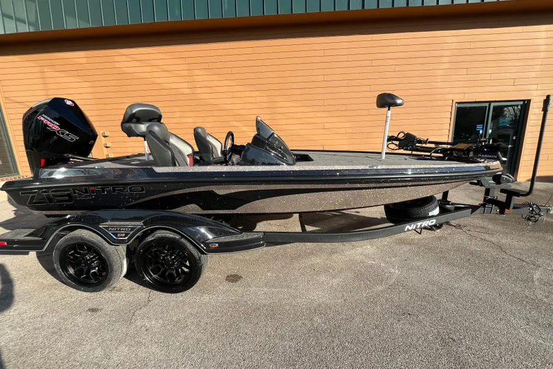 The Image of 2026 Nitro Z19 XL Pro bass boat with trailer, parked outdoors. - 0