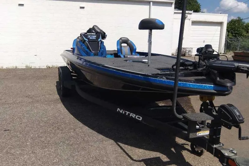 Slide: The Image of 2026 Nitro Z19 XL Pro fishing boat on trailer, parked outdoors. - 2