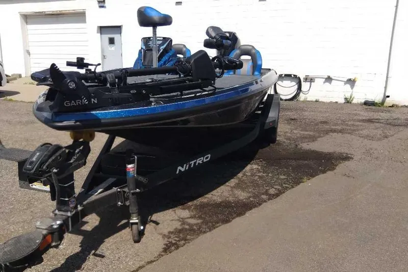 Slide: The Image of 2026 Nitro Z19 XL Pro fishing boat on trailer, parked outdoors. - 4
