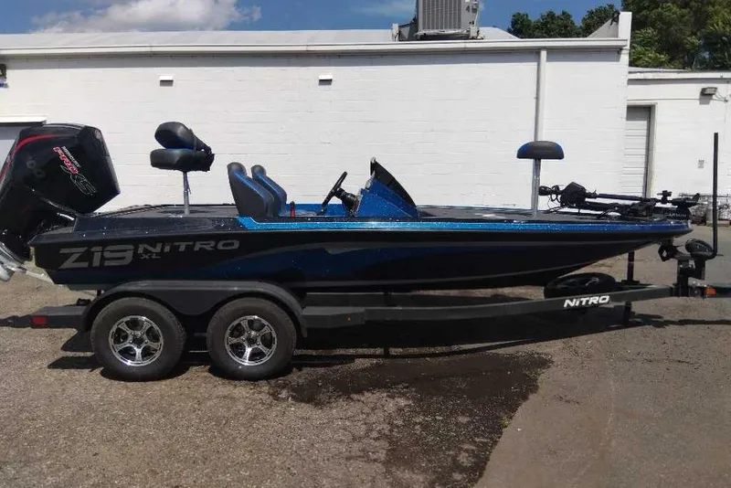 Slide: The Image of 2026 Nitro Z19 XL Pro boat on trailer, parked outdoors, side view. - 7