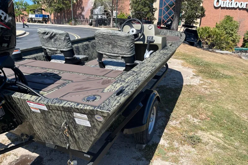 Slide: The Image of 2026 Tracker Grizzly 1754 SC boat on trailer outdoors. - 2
