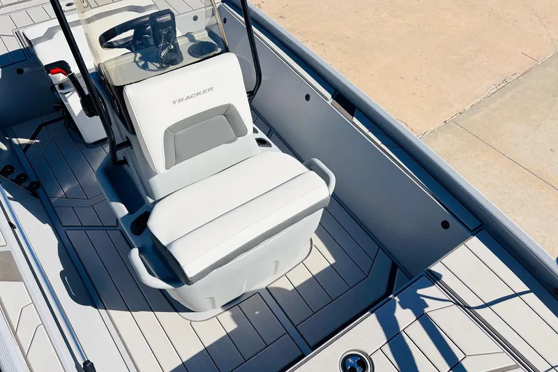 Slide: The Image of 2026 Tracker Bass Tracker Classic CC boat interior with white seating and steering console. - 15