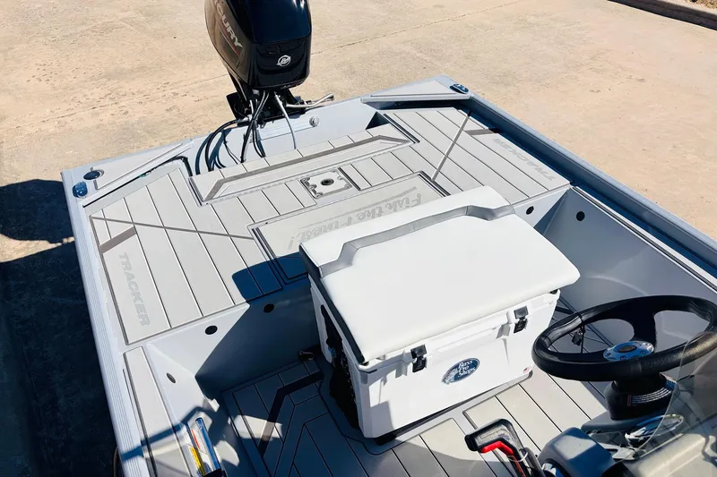 Slide: The Image of 2026 Tracker Bass Tracker Classic CC boat interior with steering wheel and motor. - 23