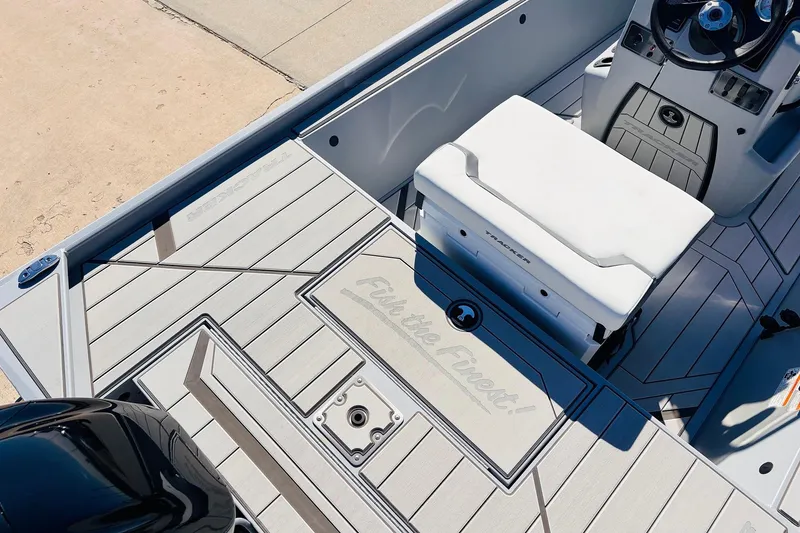 Slide: The Image of 2026 Tracker Bass Tracker Classic CC boat interior with seating and steering console. - 26