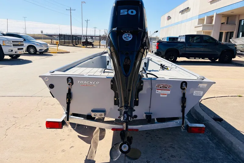 Slide: The Image of 2026 Tracker Bass Tracker Classic CC boat with 50 HP motor in parking lot. - 6