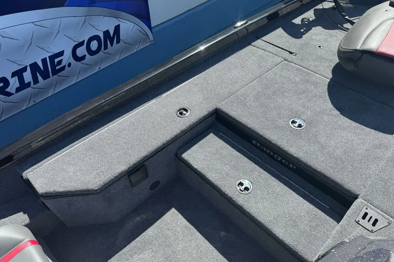 Slide: The Image of 2026 Ranger RT178 boat interior with carpeted deck and storage compartments. - 16