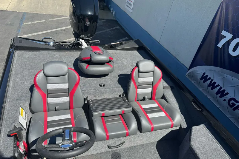 Slide: The Image of 2026 Ranger RT178 boat interior with gray and red seating, steering wheel, and motor. - 8
