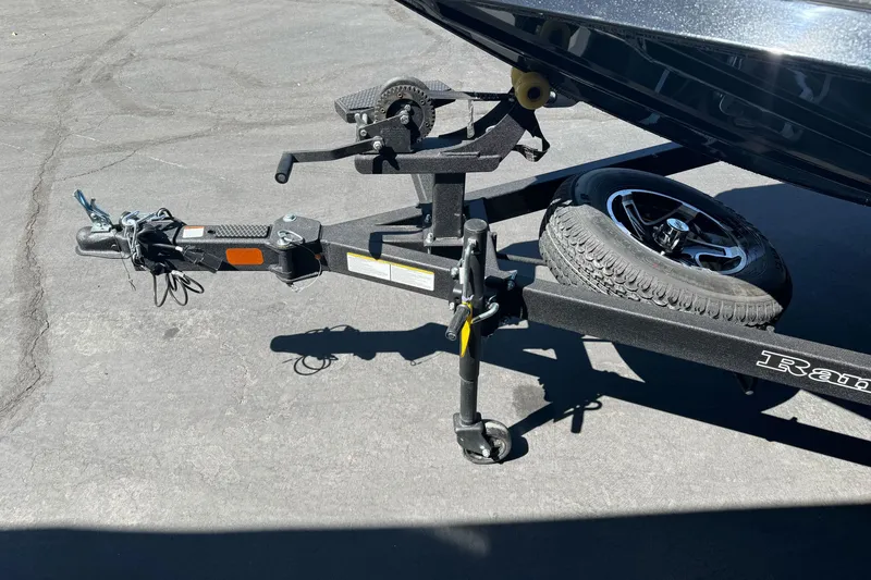 Slide: The Image of Trailer hitch of 2026 Ranger RT178 boat with spare tire on asphalt. - 6