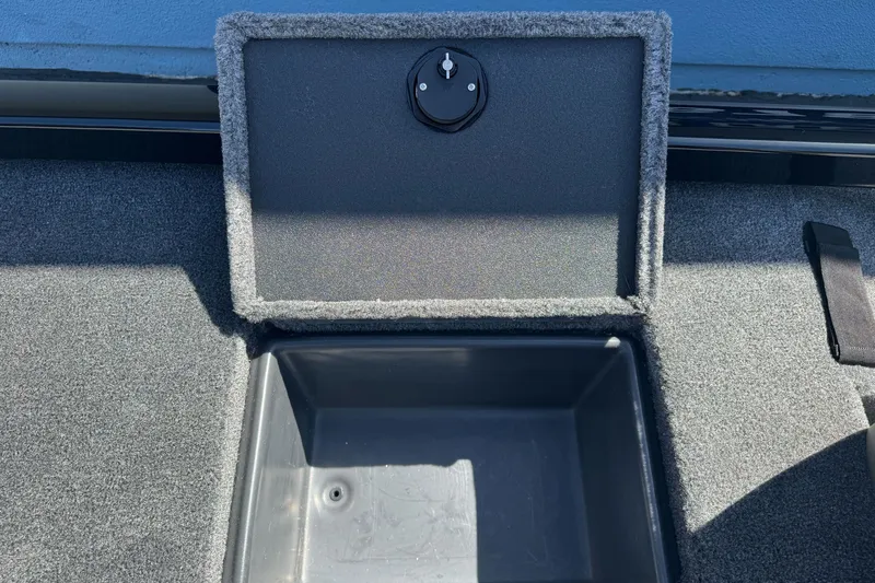 Slide: The Image of Open storage compartment on 2026 Ranger RT178 boat, featuring carpeted interior and secure latch. - 10