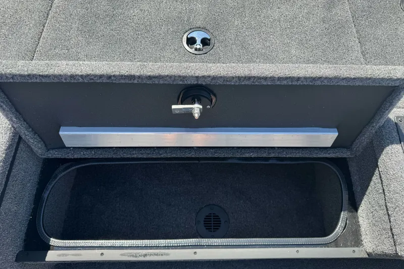 Slide: The Image of 2026 Ranger RT178 boat storage compartment with secure lock and carpeted interior. - 18