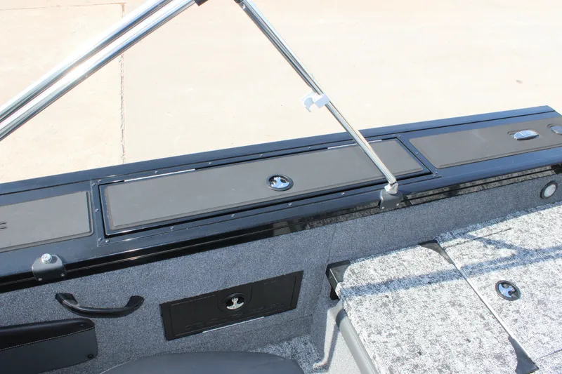 Slide: The Image of 2026 Tracker Targa V-18 Combo boat interior with storage compartments and seating. - 13