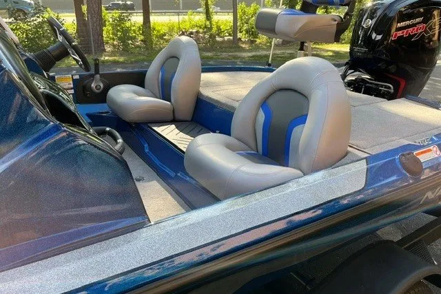 Slide: The Image of 2026 Nitro Z17 boat interior with gray and blue seating, featuring a Mercury Pro motor. - 9