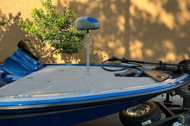Slide: The Image of 2026 Nitro Z17 boat with blue deck and fishing seat, parked on trailer. - 7