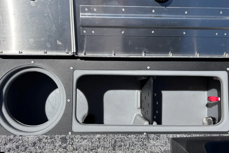 Slide: The Image of 2026 Tracker Pro Guide V-16 SC boat storage compartments and cup holder. - 26