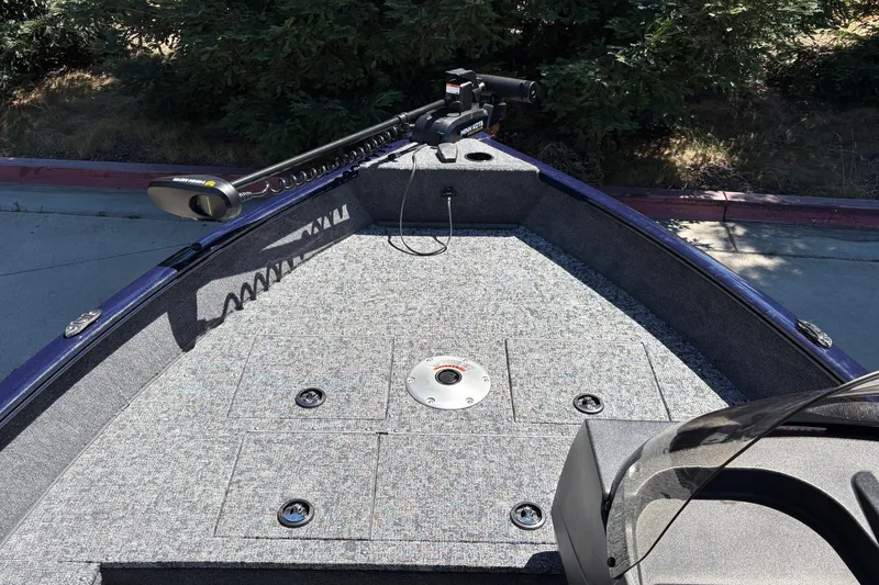 Slide: The Image of 2026 Tracker Pro Guide V-16 SC boat deck with trolling motor, carpeted surface. - 22