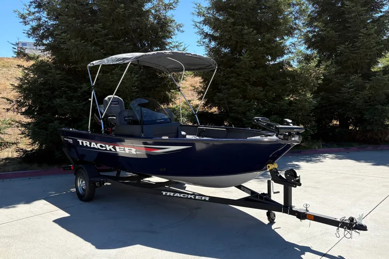 Slide: The Image of 2026 Tracker Pro Guide V-16 SC boat on trailer, parked outdoors. - 5