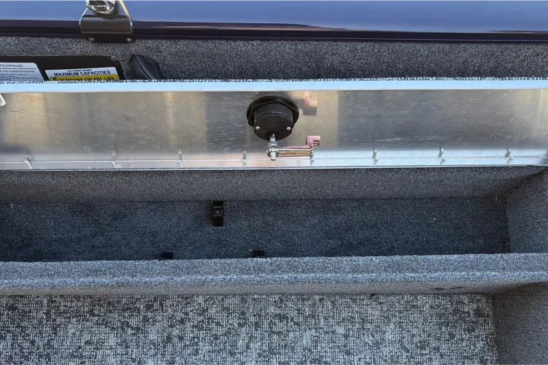 Slide: The Image of 2026 Tracker Pro Guide V-16 SC boat interior storage compartment with carpeted finish. - 30