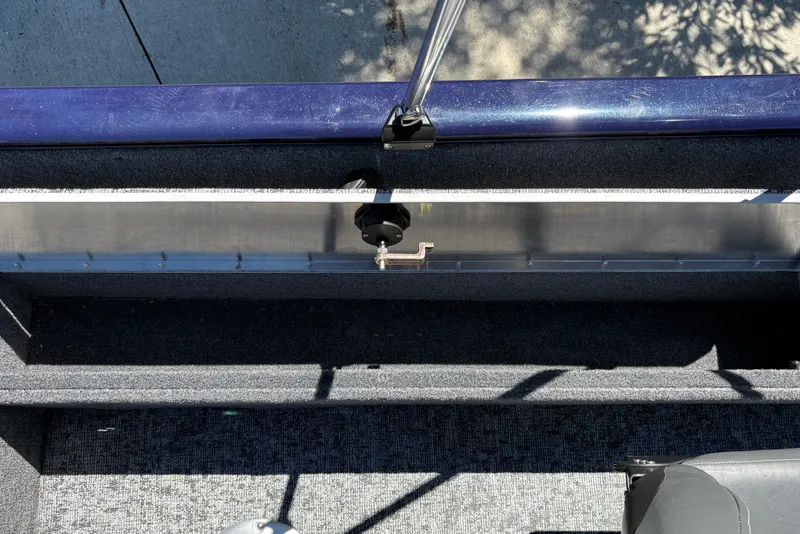 Slide: The Image of 2026 Tracker Pro Guide V-16 SC boat interior with carpeted flooring and metal railing. - 28