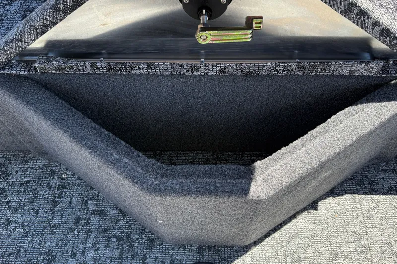 Slide: The Image of Interior view of 2026 Tracker Pro Guide V-16 SC boat, featuring carpeted storage compartment. - 34