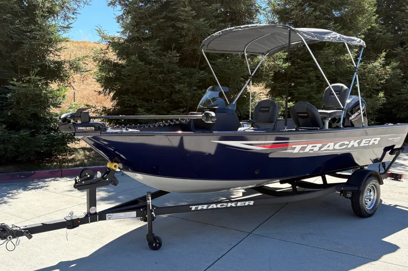 Slide: The Image of 2026 Tracker Pro Guide V-16 SC boat on trailer, parked outdoors. - 7