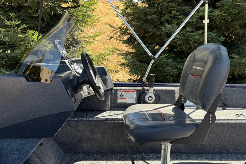 Slide: The Image of 2026 Tracker Pro Guide V-16 SC boat interior with steering wheel and seat. - 23