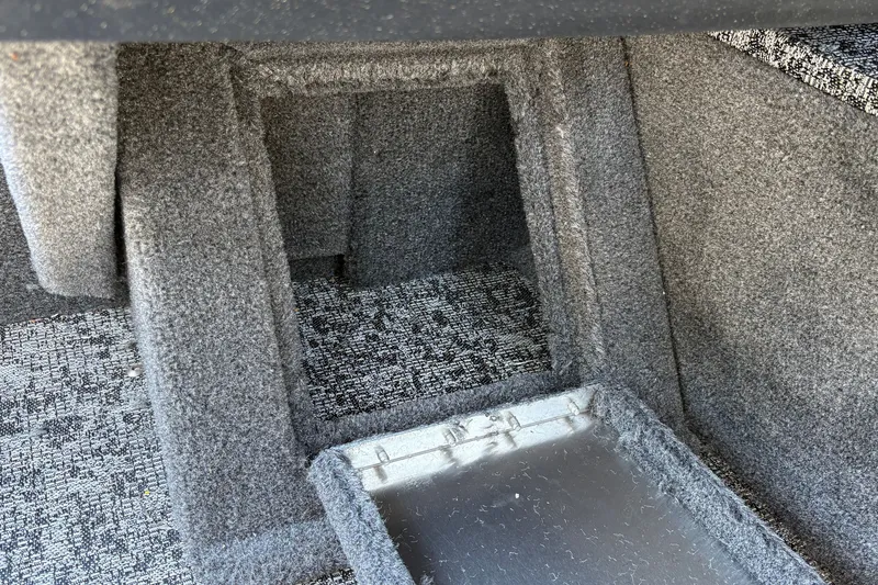 Slide: The Image of Carpeted storage compartment in 2026 Tracker Pro Guide V-16 SC boat interior. - 35