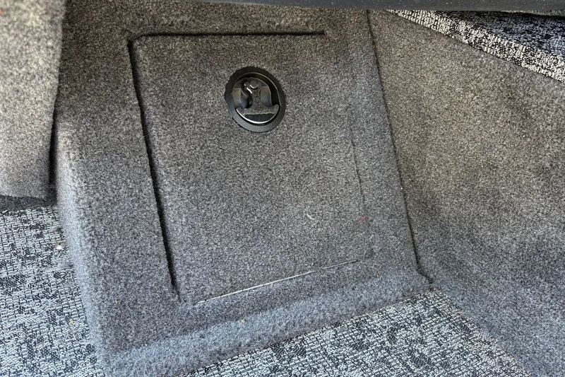 Slide: The Image of Carpeted storage compartment in 2026 Tracker Pro Guide V-16 SC boat interior. - 39