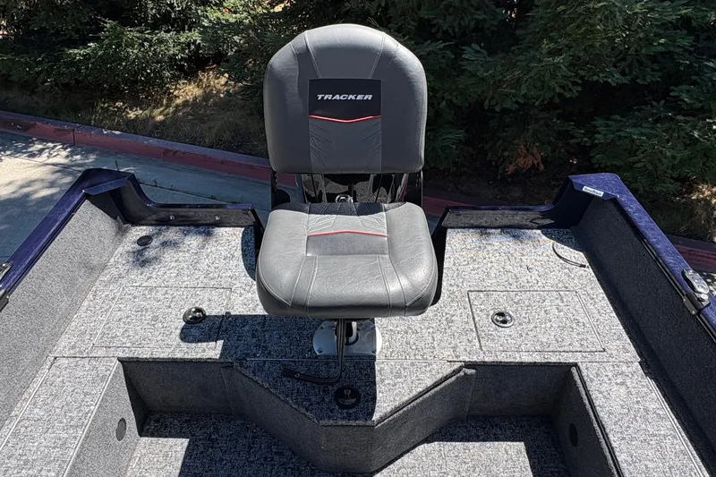 Slide: The Image of 2026 Tracker Pro Guide V-16 SC boat seat on a textured deck. - 25