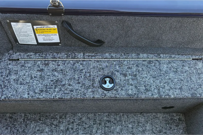 Slide: The Image of 2026 Tracker Pro Guide V-16 SC boat interior with storage compartment and capacity label. - 37