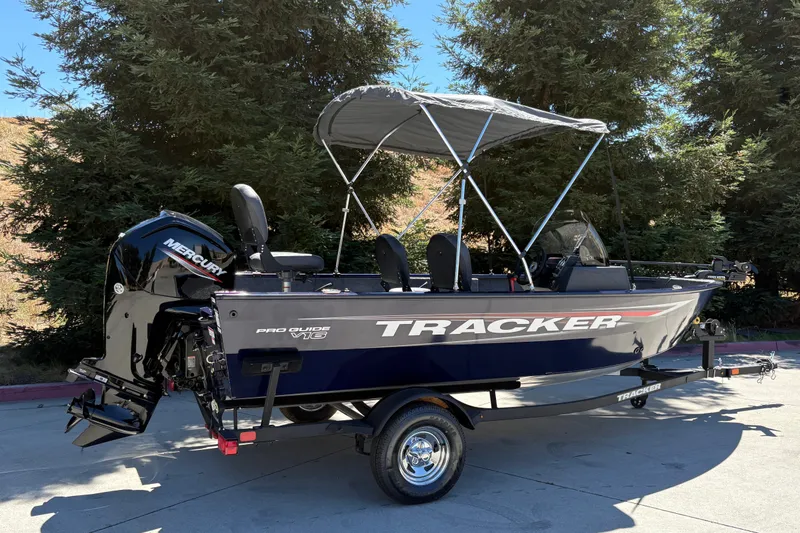 Slide: The Image of 2026 Tracker Pro Guide V-16 SC boat with Mercury engine, parked outdoors. - 3