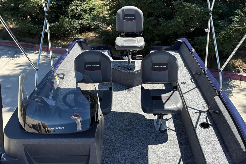 Slide: The Image of 2026 Tracker Pro Guide V-16 SC boat interior with seating and steering console. - 16