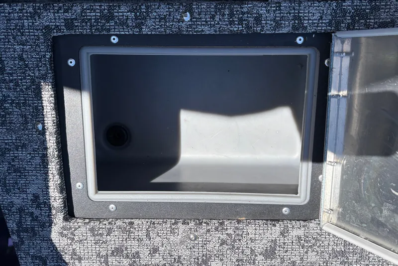 Slide: The Image of Open storage compartment on 2026 Tracker Pro Guide V-16 SC boat. - 27