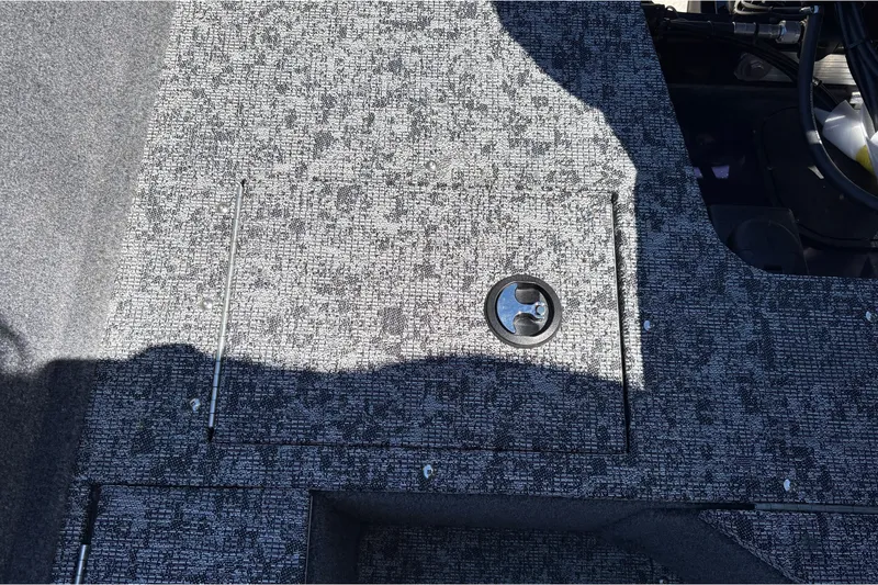 Slide: The Image of Carpeted deck of 2026 Tracker Pro Guide V-16 SC boat with storage hatch. - 38