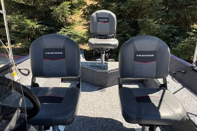 Slide: The Image of 2026 Tracker Pro Guide V-16 SC boat seats with lush greenery background. - 15