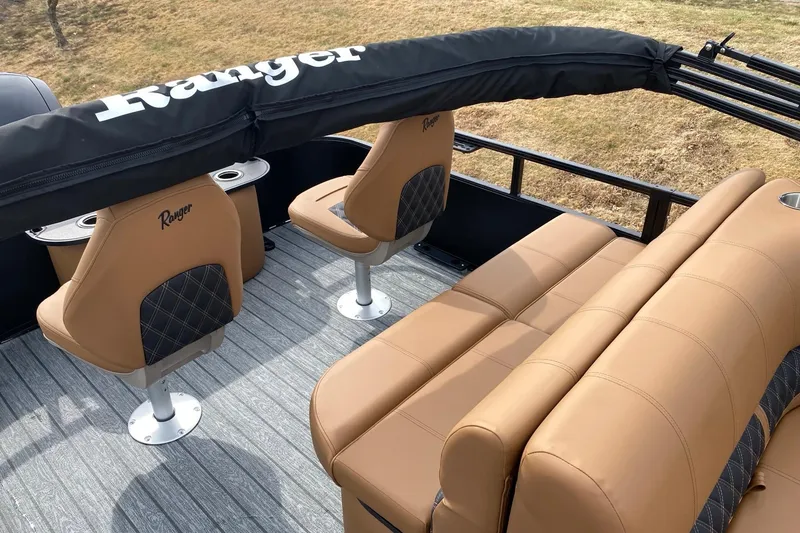 Slide: The Image of 2026 Ranger 220F boat interior with tan seating and Ranger branding. - 62
