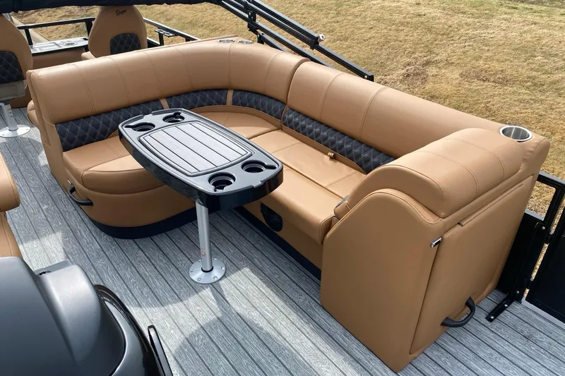 Slide: The Image of Luxurious seating area on 2026 Ranger 220F boat with tan upholstery and central table. - 63