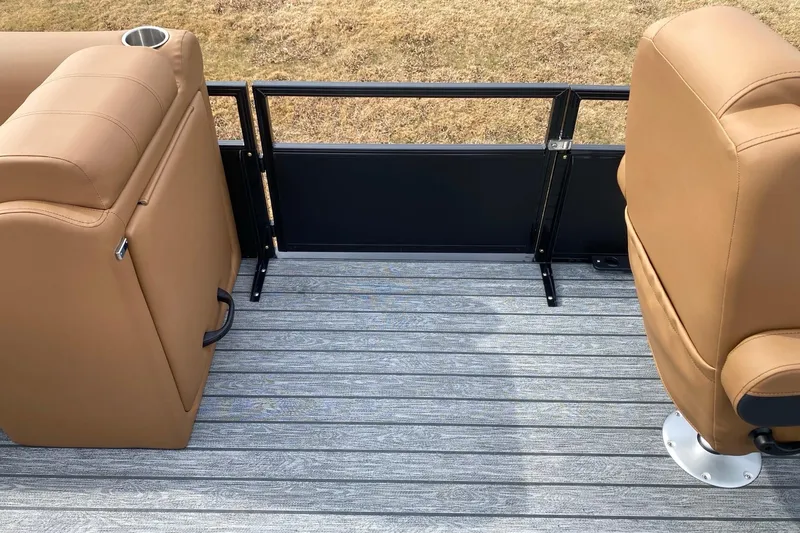 Slide: The Image of 2026 Ranger 220F boat interior with tan seats and gray flooring. - 64